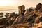 A Man Does Zen Yoga on Boulders at Sunrise in Nha Trang