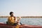 Man with a dog in a canoe on the lake.