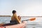 Man with a dog in a canoe on the lake.