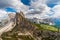 Man with dog is looking the most beautiful peak of Seceda at the amazing Val Gardena valley in Dolomites mountains, Alps, Italy