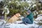 The man and the dog sitting in a snowy winter forest