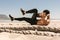 Man doing abdomen workout at the beach