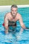 Man doing aqua bike in swimming pool