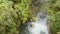 Man Doing Canyoning Jumping From A Waterfall