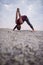 Man doing the clasp hands forward fold pose at dusk