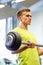 Man doing exercise with barbell in gym