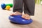 Man doing flatfoot correction gymnastic exercise balancing on massage cushion at home