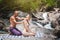 a man is doing a massage for a woman in the nature next to a waterfall. Beauty, nature, health, meditation, pleasure, relaxation