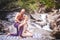 a man is doing a massage for a woman in the nature next to a waterfall. Beauty, nature, health, meditation, pleasure, relaxation