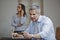 Man doing online shopping with his wife talking on a mobile phone