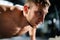 Man doing push ups in a gym. Exhaling and inhaling after push-ups and exercise. Perfect for fitness and workout. Young sports man