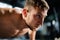 Man doing push ups in a gym. Exhaling and inhaling after push-ups and exercise. Perfect for fitness and workout. Young sports man