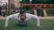 Man is doing push-ups outdoors