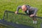 Man doing pushups outdoors on a bench