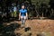 Man doing workout jump up in air exercise in forest. Handsome sportsman wearing sportswear is jumping up in air exercise.