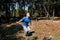 Man doing workout jump up in air exercise in forest. Handsome sportsman wearing sportswear is jumping up in air exercise.