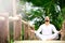 Man doing yoga in tropic jungle bridge