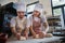 Man with down syndrom helping prepair bread in bakery with his colleague. Concept of integration people with disability