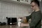 Man with down syndrome preparing morning coffee with milk