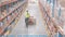 Man dragging a fork lift inside a warehouse