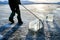 A man drags a large block of sawn river ice. workers mine large cubes of natural river ice