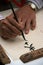 A man is drawing a chinese calligraphy in a street of Hanoi (Vietnam)