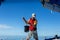 A man draws water from the sea with a bucket for washing the deck