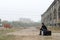 Man dressed in black sitting smoking