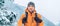 Man dressed bright orange softshell jacket with backpack have trekking on the winter mountains route. Active people or survival in