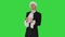 Man dressed in courtier frock coat and white wig thinking and fidgeting with his fingers on a Green Screen, Chroma Key.