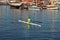 Man dressed in green doing canoeing.