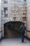 Man dressed in a suit walking towards Duke of Wellington entrance to Hyde Park Corner Subway, London, UK