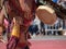 Man dressed in traditional Aztec garb beats on a drum during a m