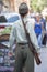 Man dressed in the uniform of the Ukrainian insurgent army with a rifle invites tourists to enter the restaurant on the street in