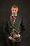 Man dressed up in tuxedo with rose. Groom with tie and red rose. her elegant valentine. man tuxedo hold rose. man in