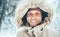 Man dressed in Warm Hooded Casual Parka Jacket Outerwear walking in snowy forest cheerful smiling face portrait. Outdoor time and