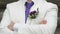 Man dressed in a white suit with purple tie