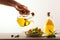 Man dressing Mediterranean salad on wooden table isolated background