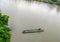 a man drifting his boat on Mentarang River, Malinau, Borneo