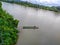 a man drifting his boat on Mentarang River, Malinau, Borneo