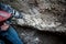 Man with drilling machine destroying a thick concrete wall