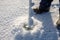 A man drills holes in the ice for ice fishing with an electric auger