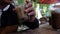 Man drink glass of iced coffee from a paper straw at cafe. Slow motion shot