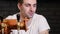 Man drinking beer and enjoying beverage at pub bar HD close-up slow-motion video. Male guest tastes lager from glasses