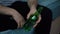 man drinking beer from glass green bottle while sitting on sofa