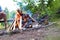 Man drinking beer while sitting on bench at park with bonfire