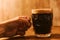 Man drinking dark beer in british dimpled glass pint mug