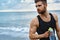 Man Drinking Refreshing Water After Workout At Beach. Drink