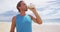 Man drinking sports drink after shaking bottle with protein powder