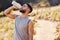 Man, drinking or water in nature or runner with bottle, workout or exercise for health. Male athlete and liquid or